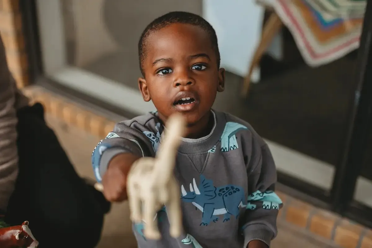 A child sharing a toy animal during play
