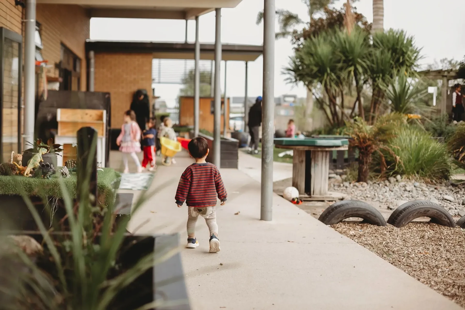 A child walking through Canopy’s outdoor play space