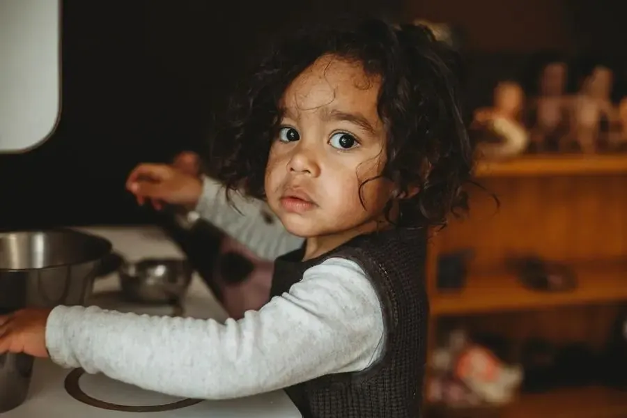 A child exploring kitchen play