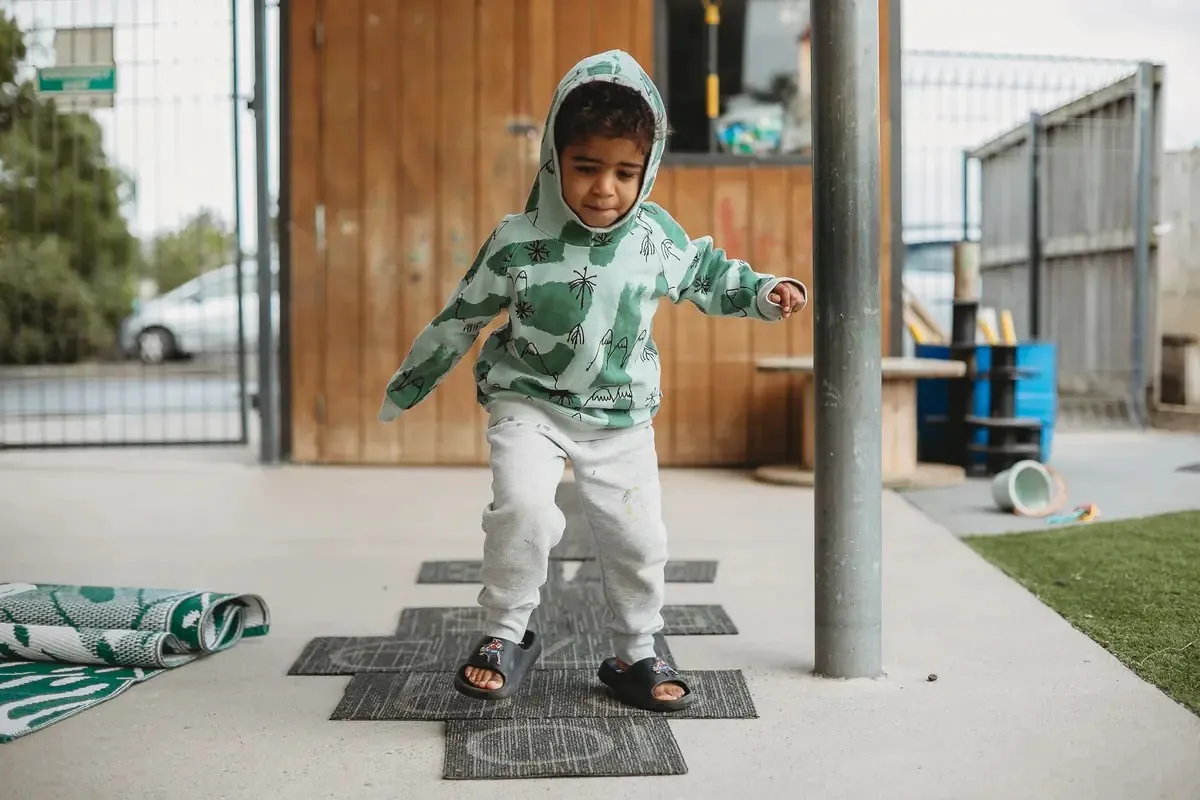 A child balancing during outdoor play